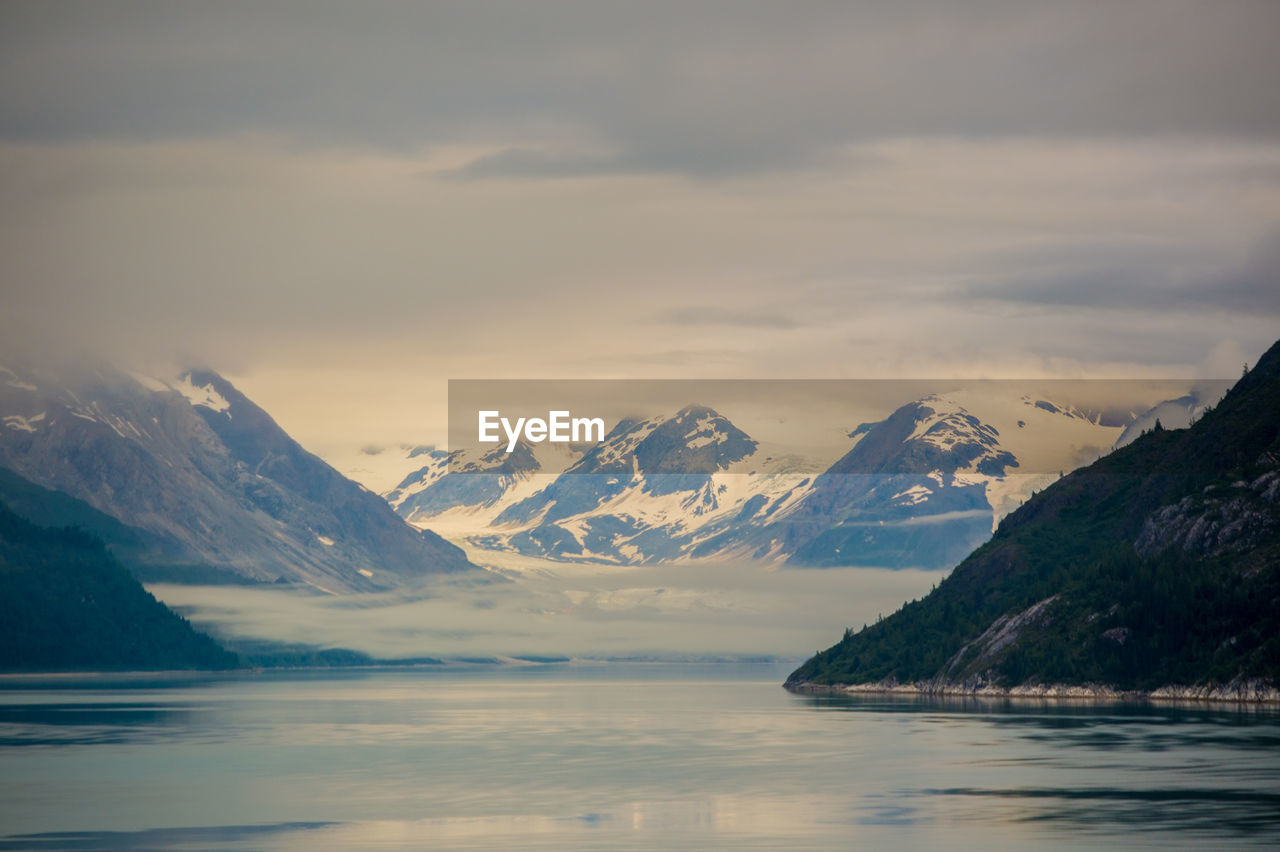 Scenic view of lake and mountains against sky