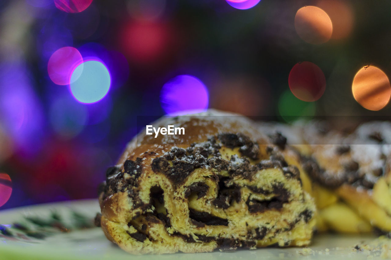 Chocolate cake with christmas lights on the background
