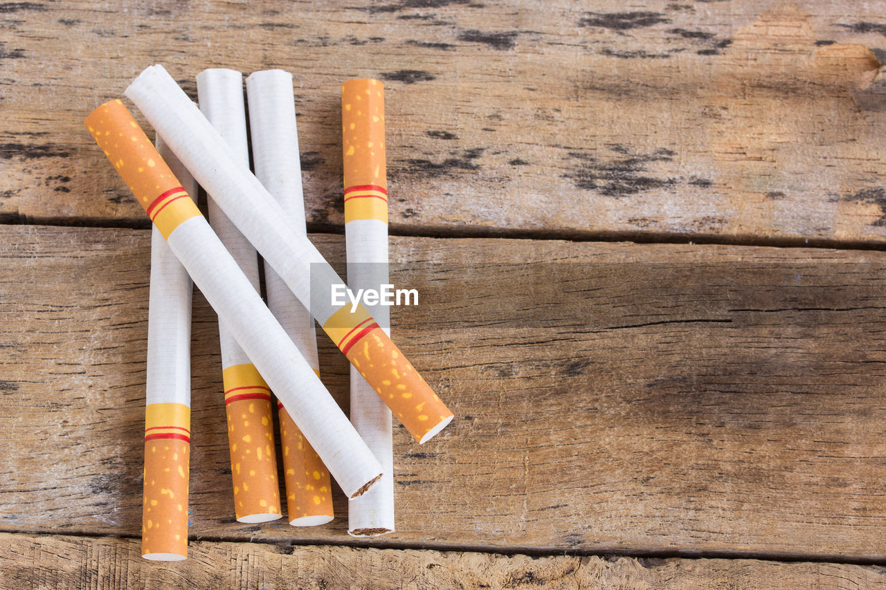 Cigarette roll on old wooden table background