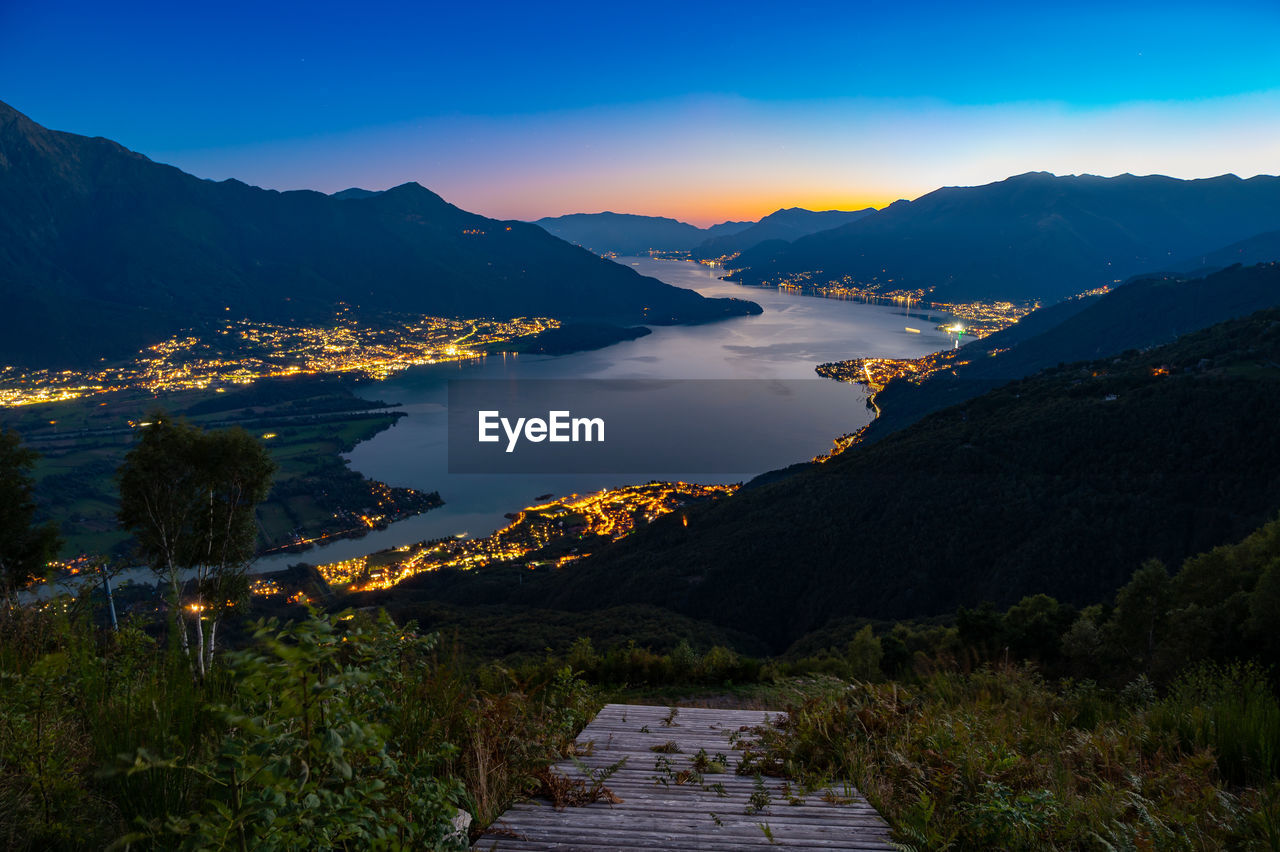 Lake como, photographed by gera lario, in the evening. view of towns and the upper lake mountains.