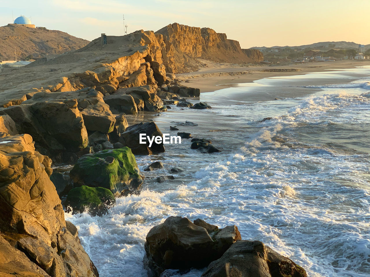 Scenic view of cliffs by the sea against sky at lobitos peru