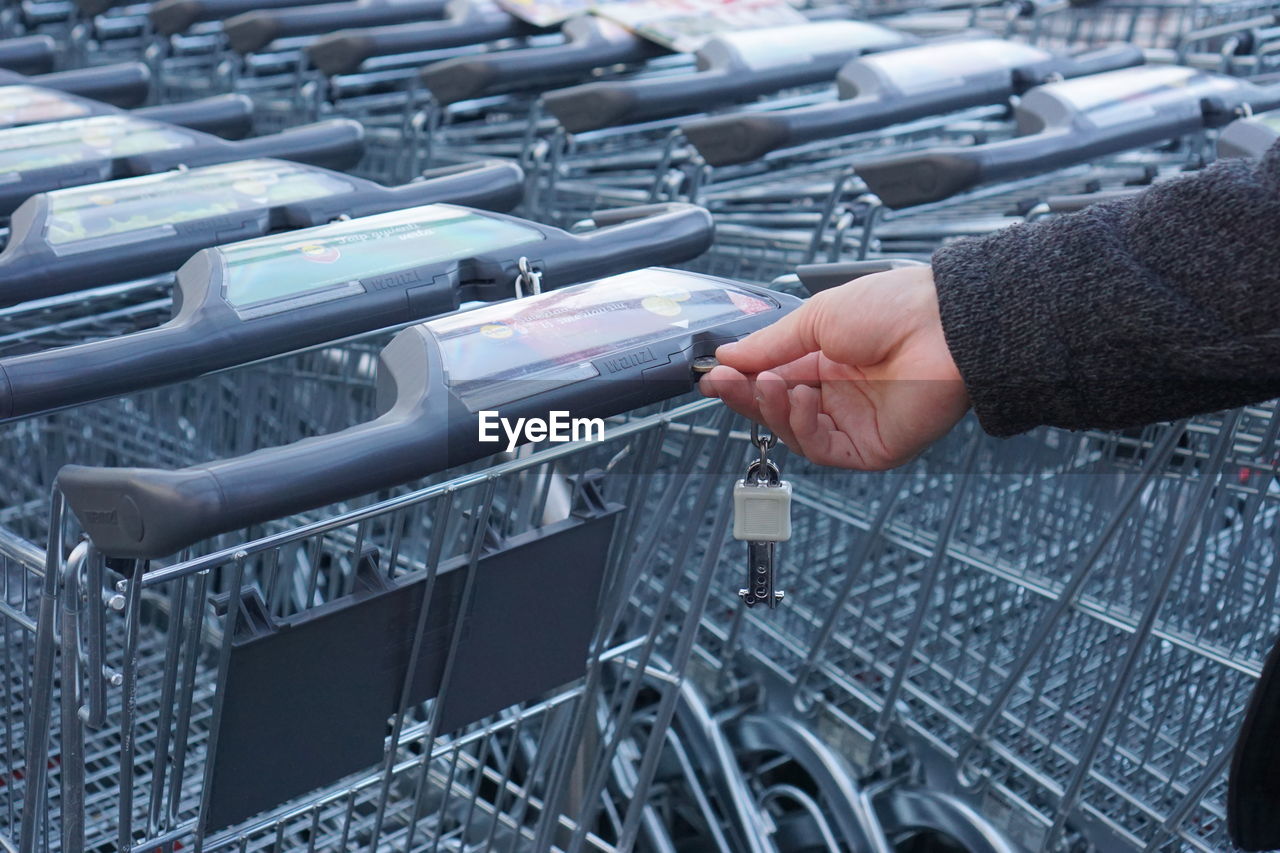Person unlocking shopping cart
