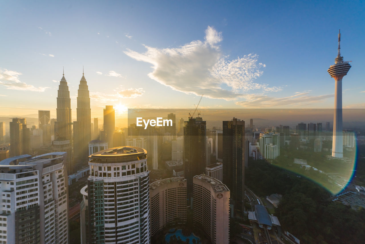 Cityscape during sunset seen through window