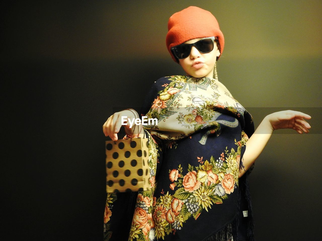 Portrait of girl sunglasses standing against wall