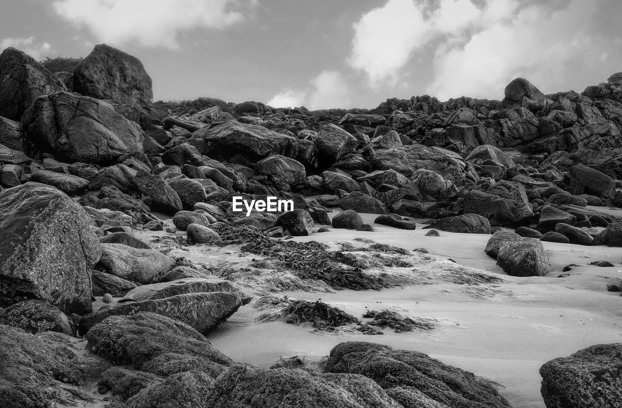 Scenic view of rocks on land against sky