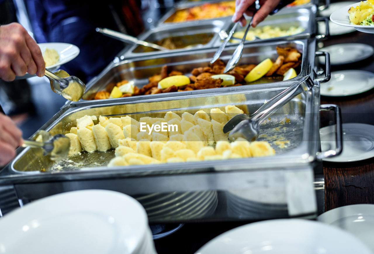 Cropped image of hands taking food