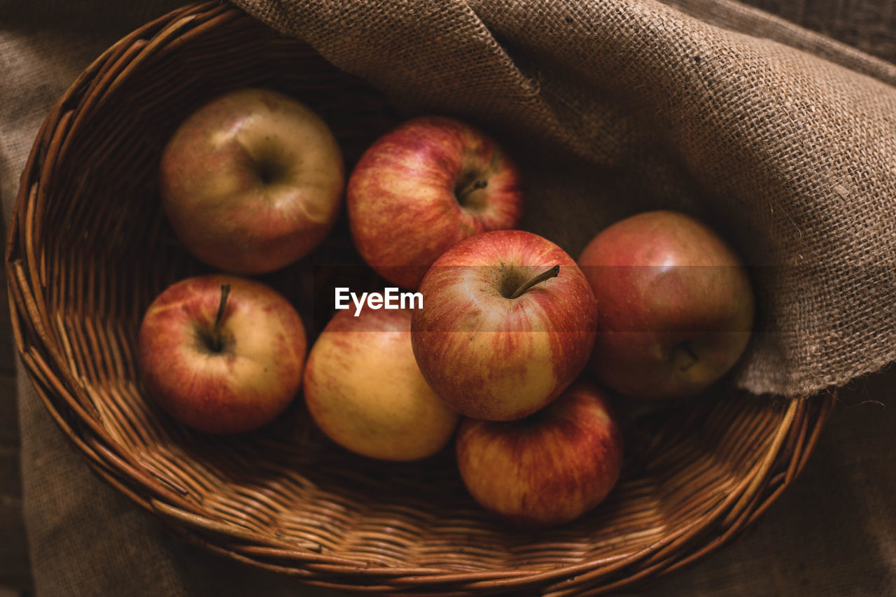 Apples in basket on table