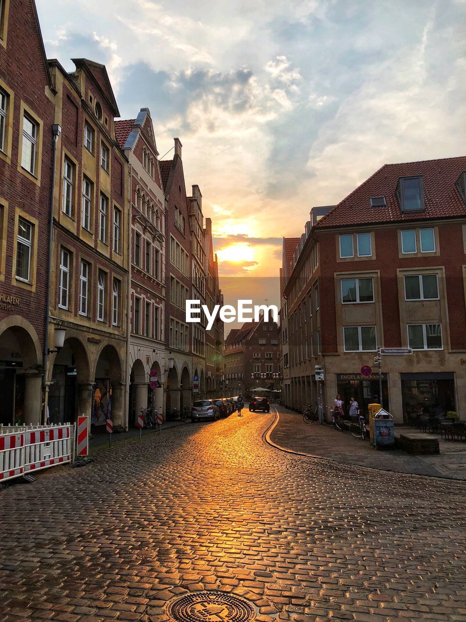 STREET AMIDST BUILDINGS AGAINST SKY