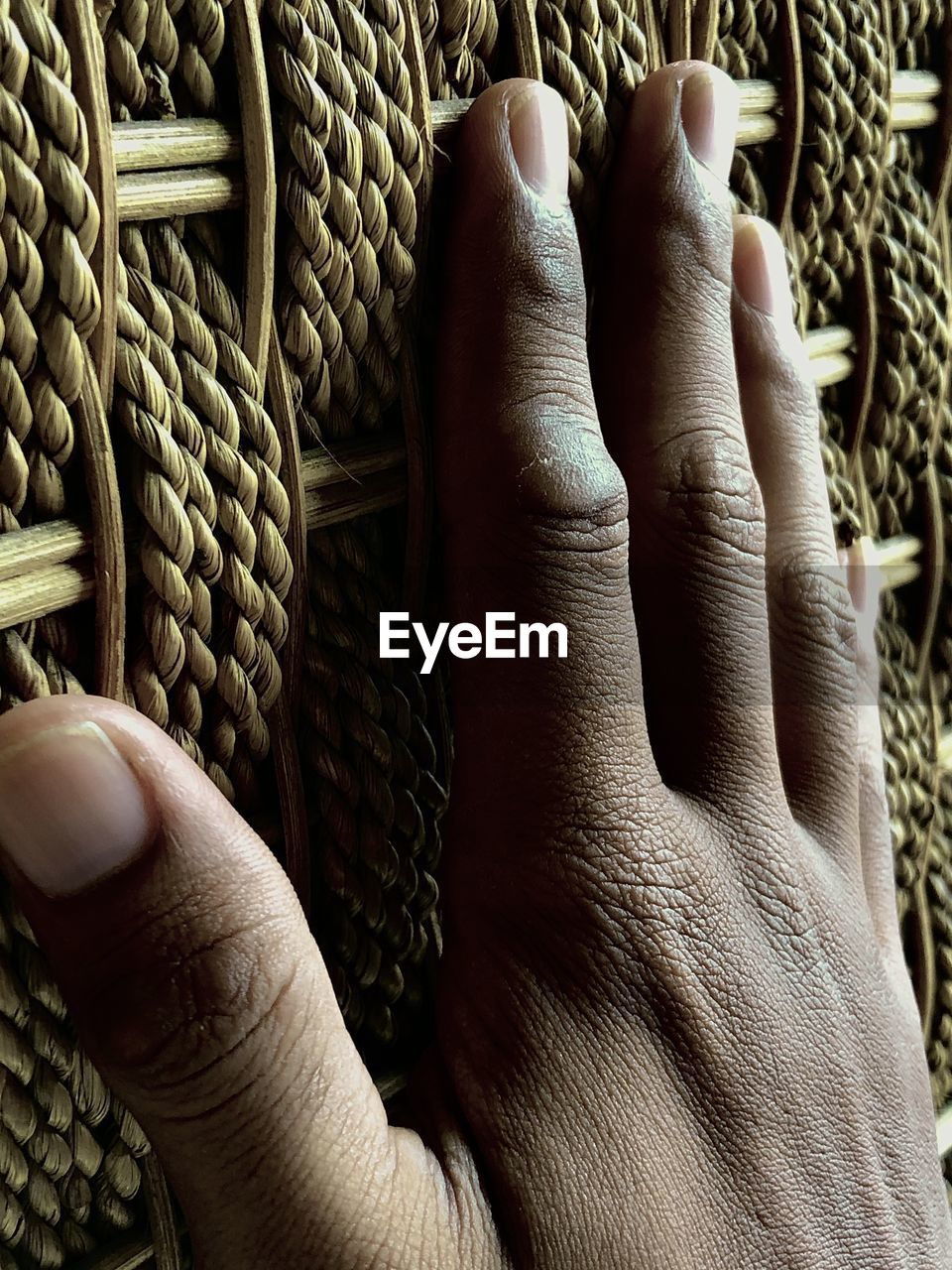 CLOSE-UP OF MAN HOLDING BASKET IN WICKER