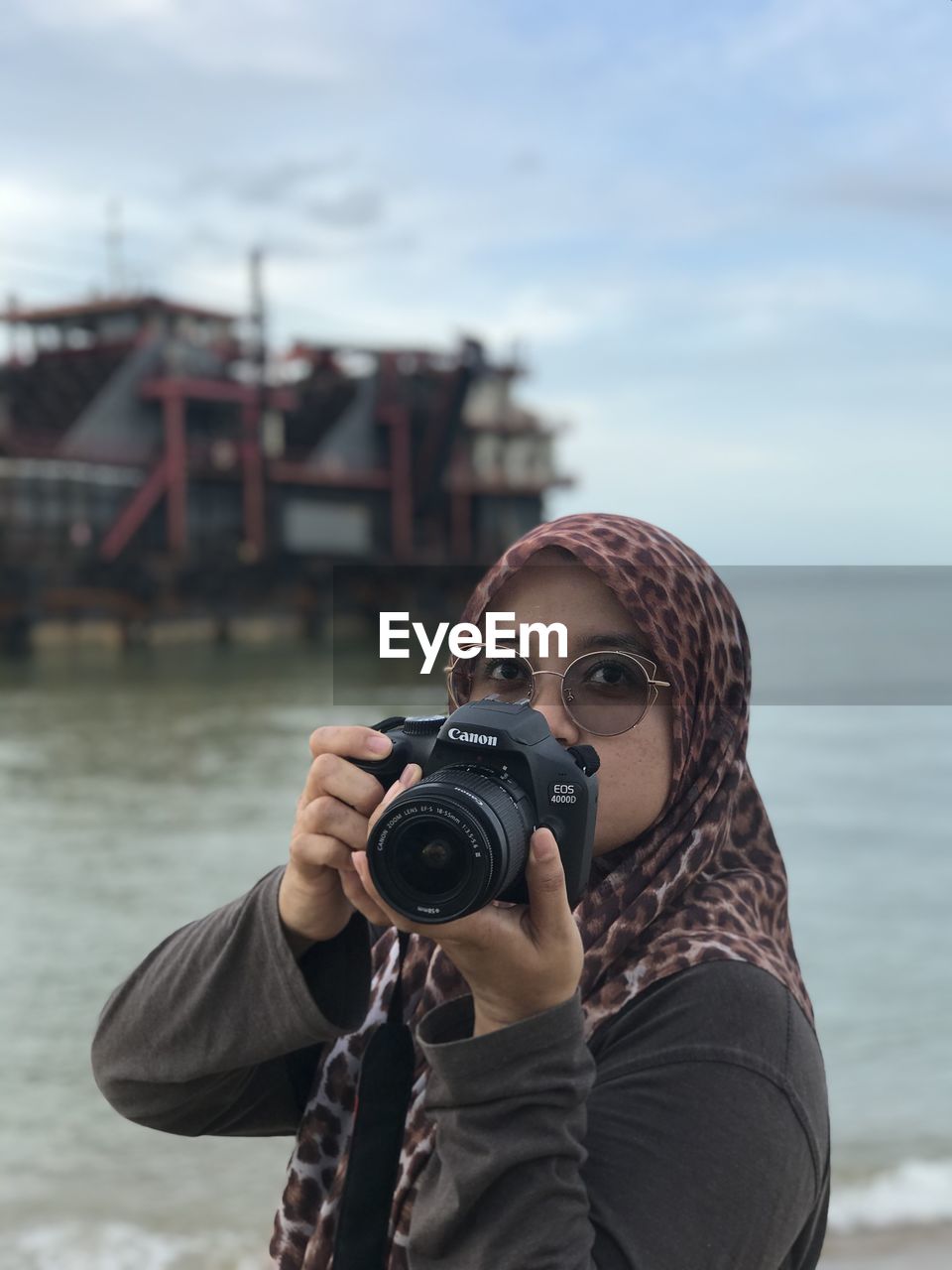 PORTRAIT OF WOMAN PHOTOGRAPHING