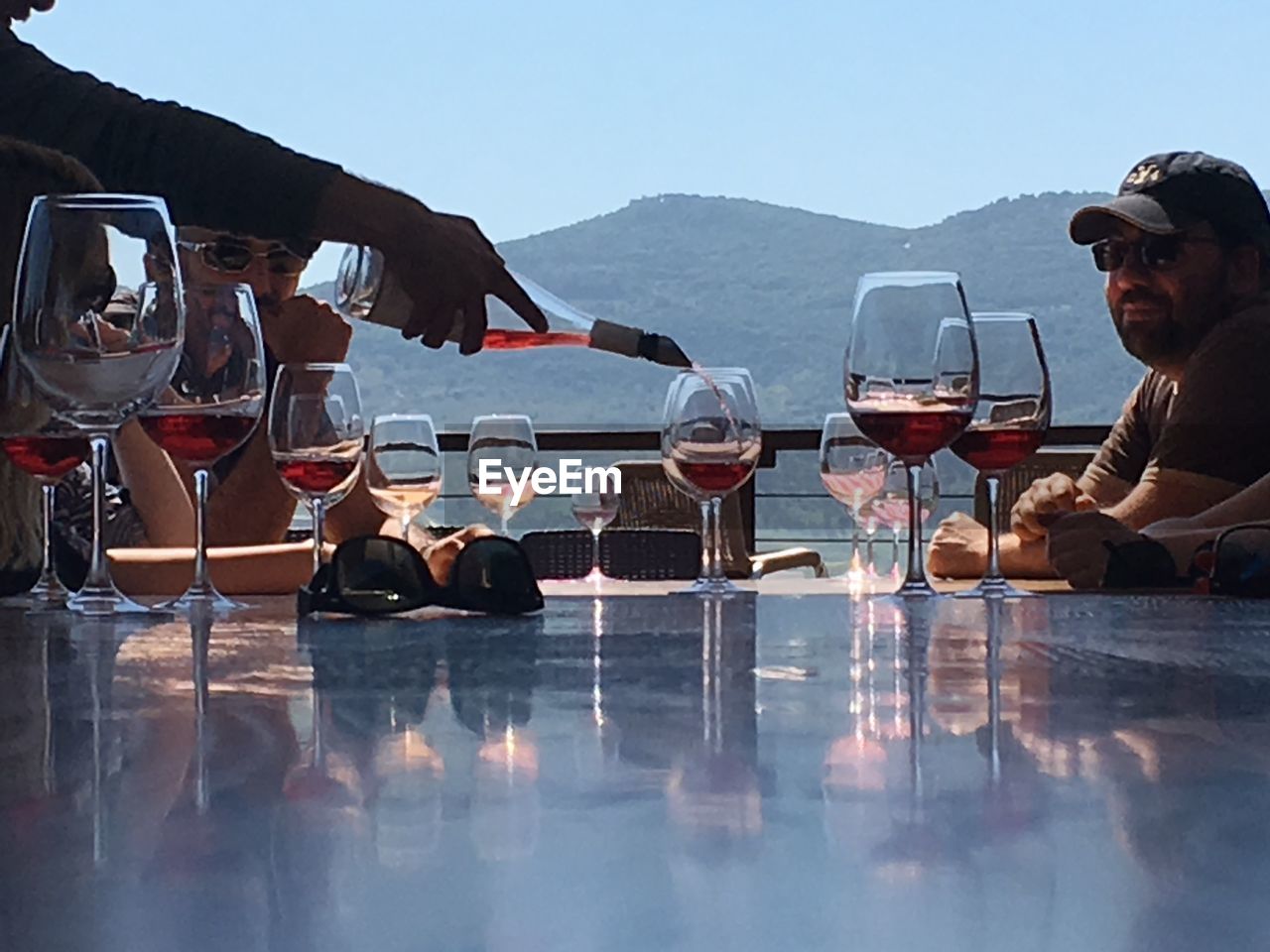 FRIENDS SITTING AT RESTAURANT TABLE