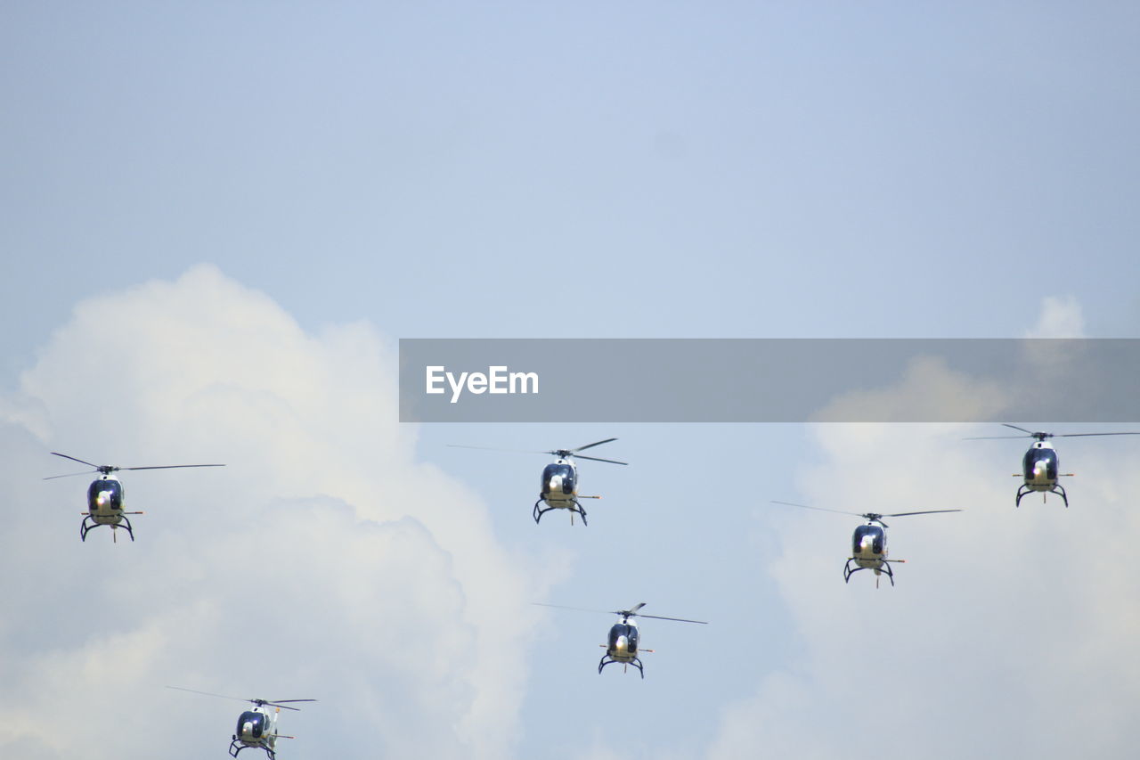 Helicopters on formation with blue sky background