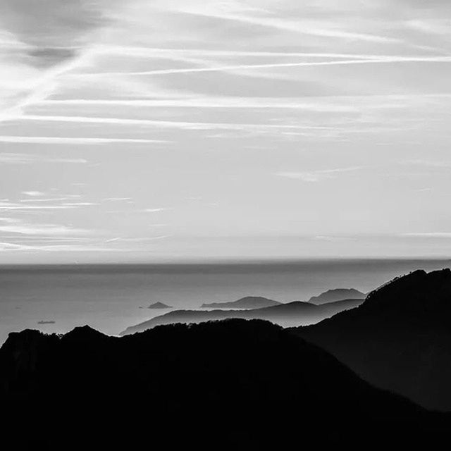 SCENIC VIEW OF SEA WITH MOUNTAIN IN BACKGROUND