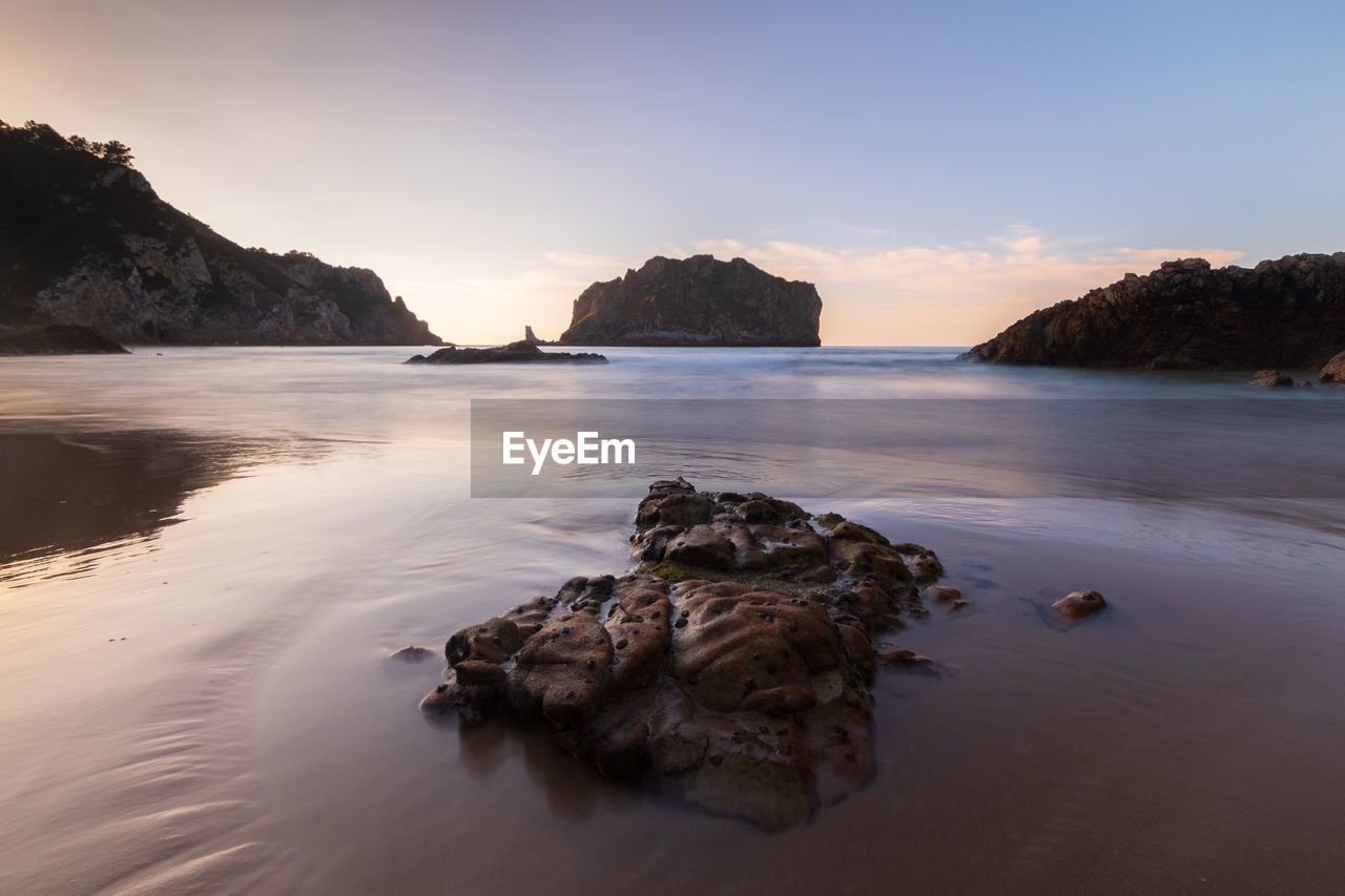 scenic view of sea at sunset