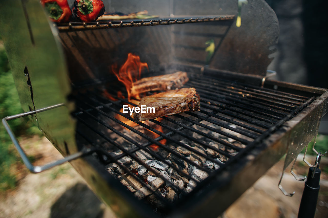 Two iberico chops on a grill with high flame