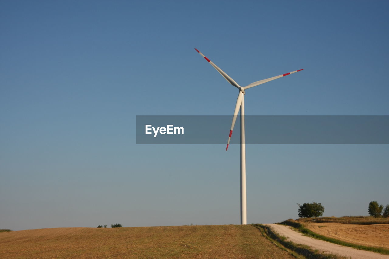 Wind turbine on field in a sunny day