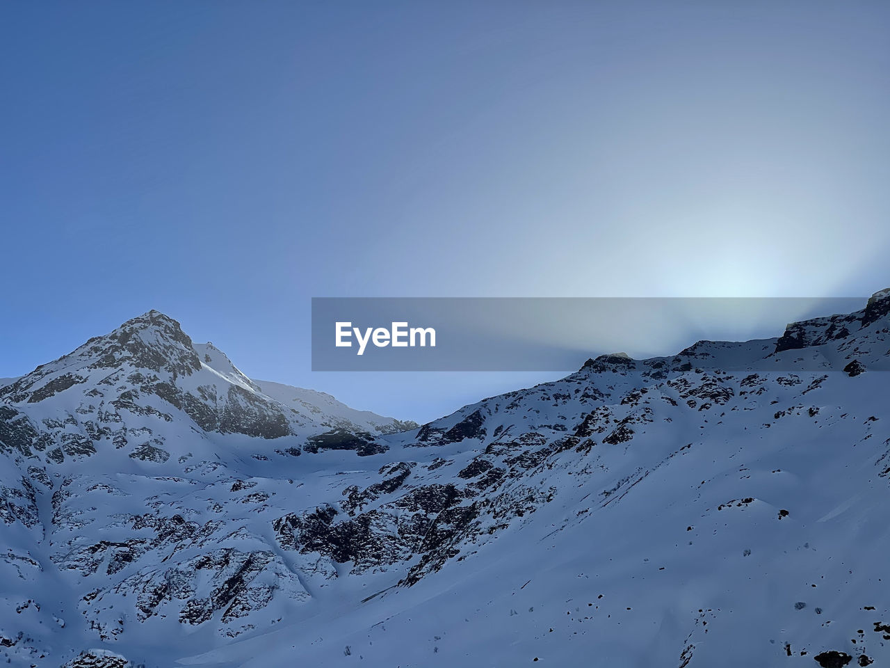 Scenic view of snowcapped mountains against clear sky