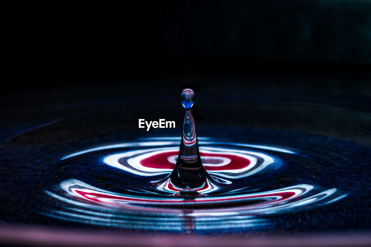 Close-up of water drop on black background