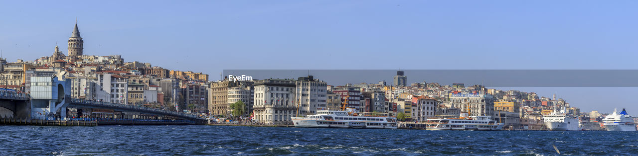 A panoramic view of Galata Tower and parts of Istanbul. This is a large file of 100+ megapixel Galata Tower Panoramic View Istanbul Bosporus Water Boats City View  Blue Skye