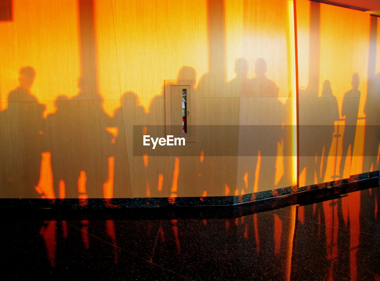 CLOSE-UP OF SILHOUETTE PEOPLE ON WATER