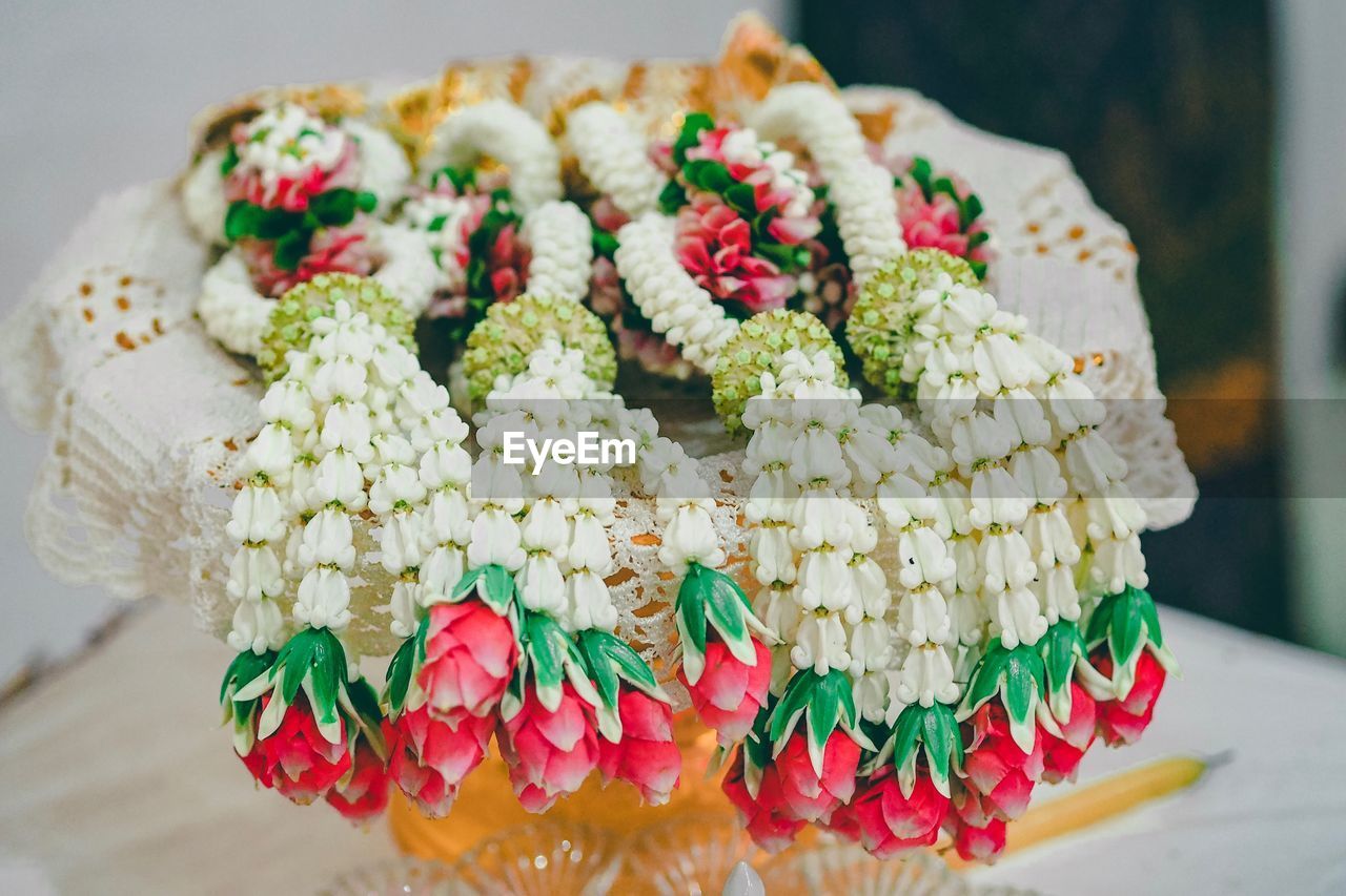 CLOSE-UP OF MULTI COLORED BOUQUET ON TABLE