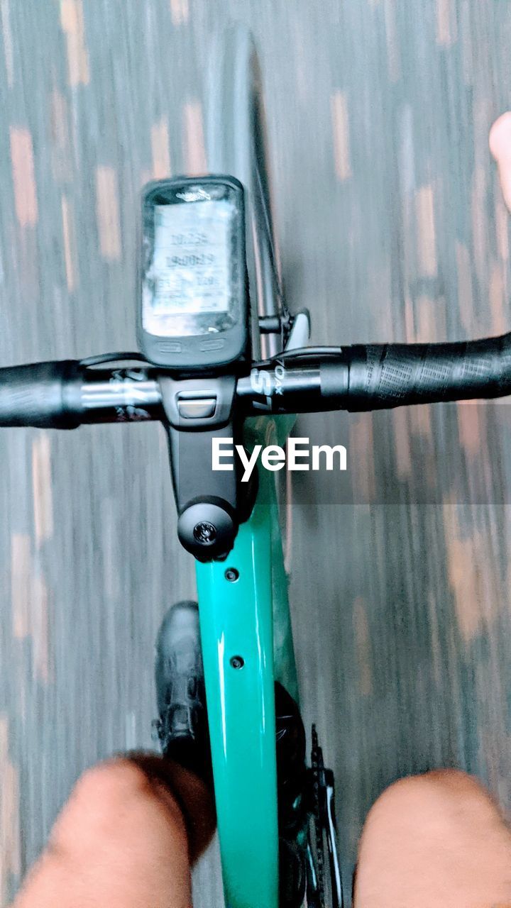 CLOSE-UP OF HAND RIDING BICYCLE