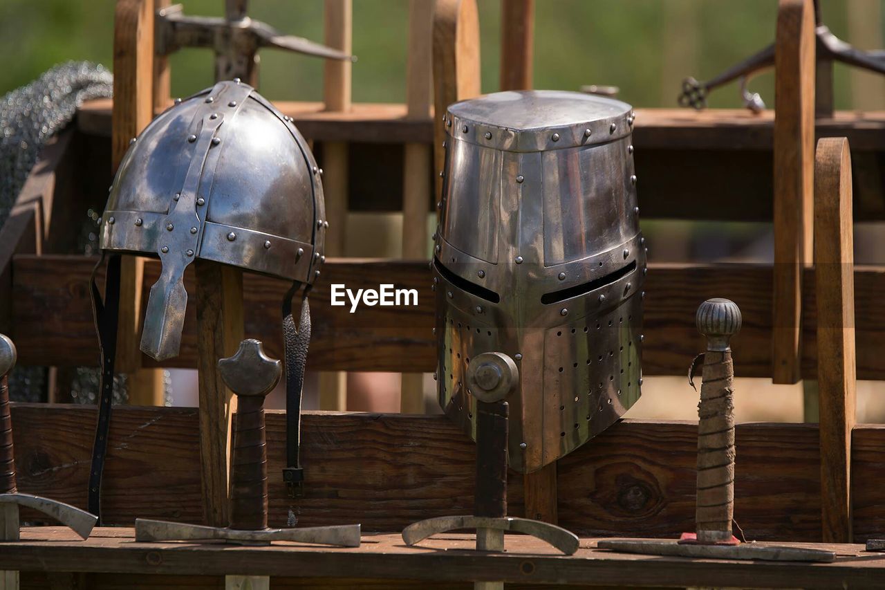 Knight helmets with swords on railing
