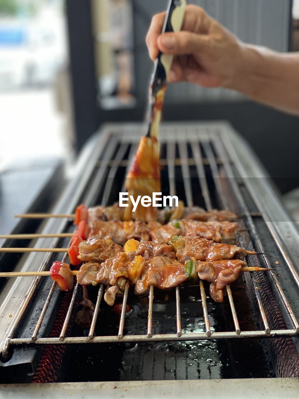 Man preparing food on barbecue grill