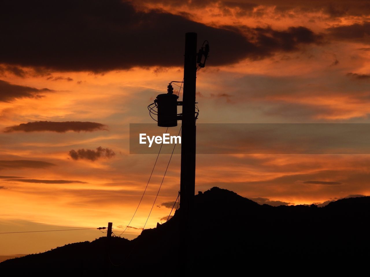 LOW ANGLE VIEW OF SILHOUETTE TOWER DURING SUNSET