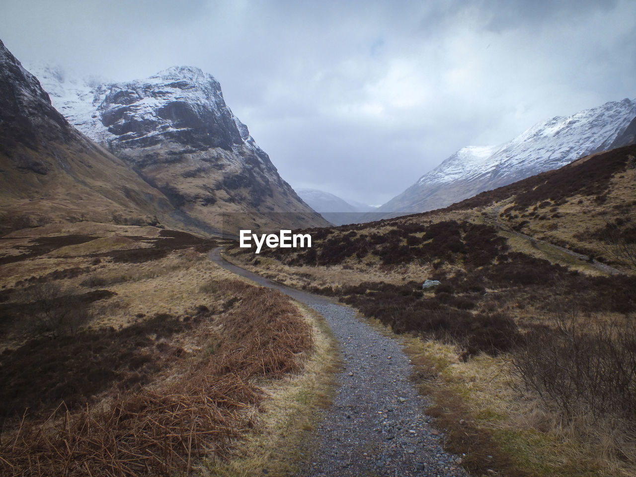 Road amidst mountains against sky