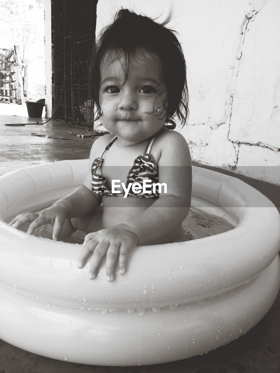 Portrait of cute baby boy in water