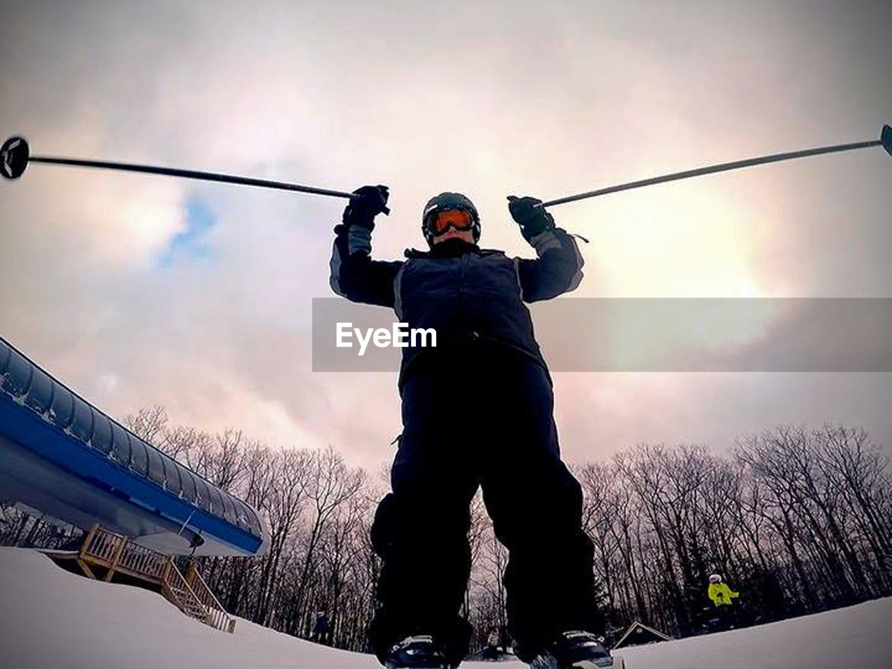 LOW ANGLE VIEW OF MAN STANDING AGAINST SKY