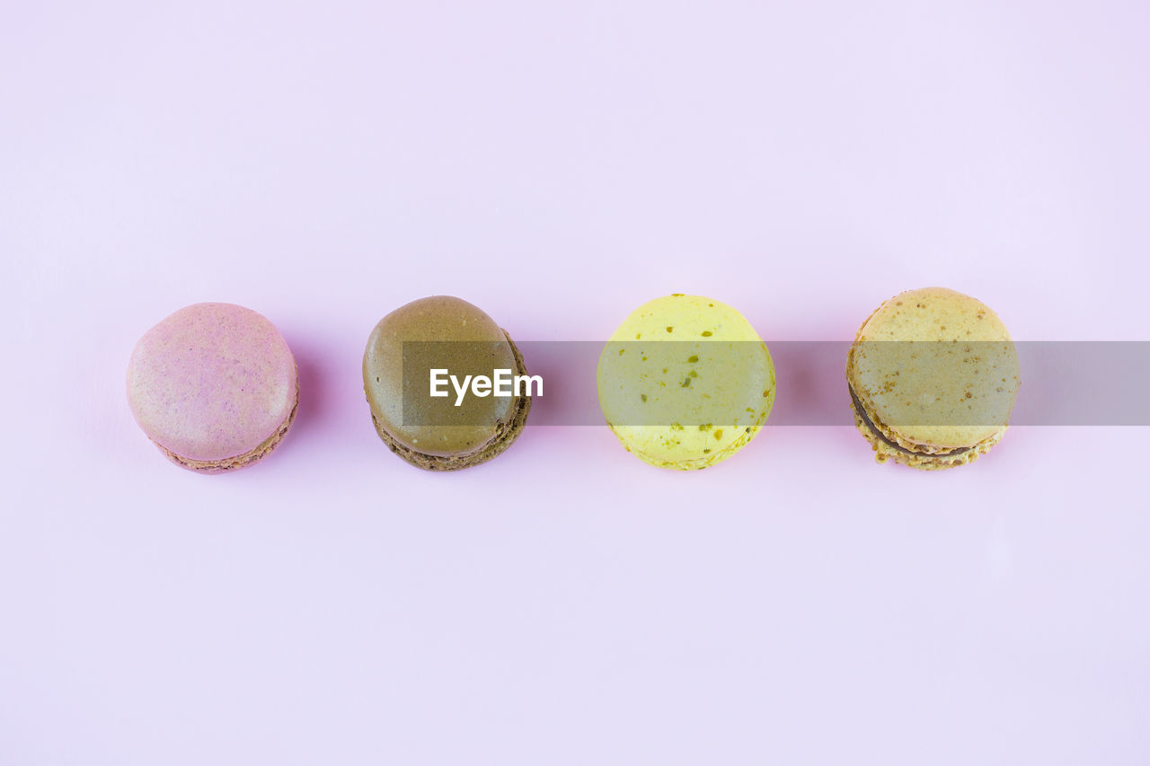 Close-up of macaroons over pink background