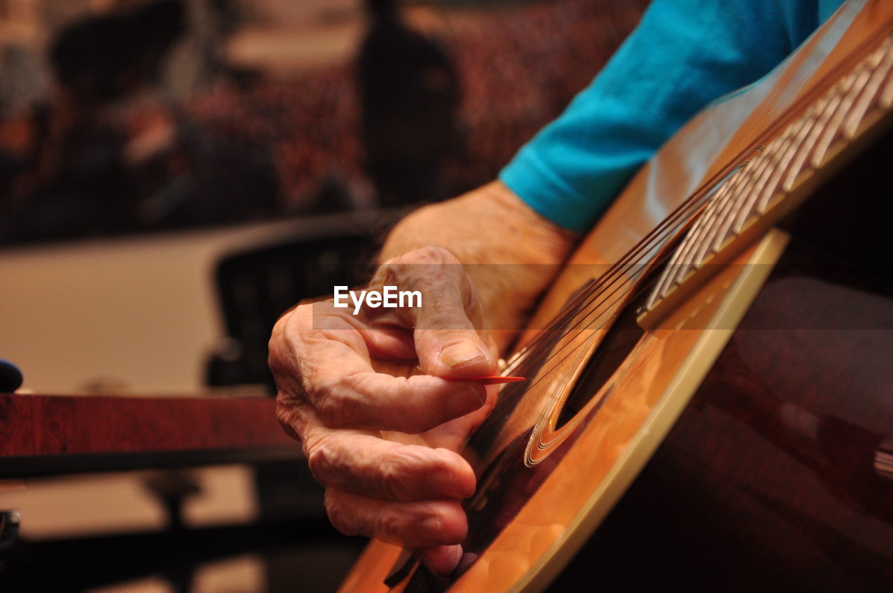 Close-up of hand holding guitar