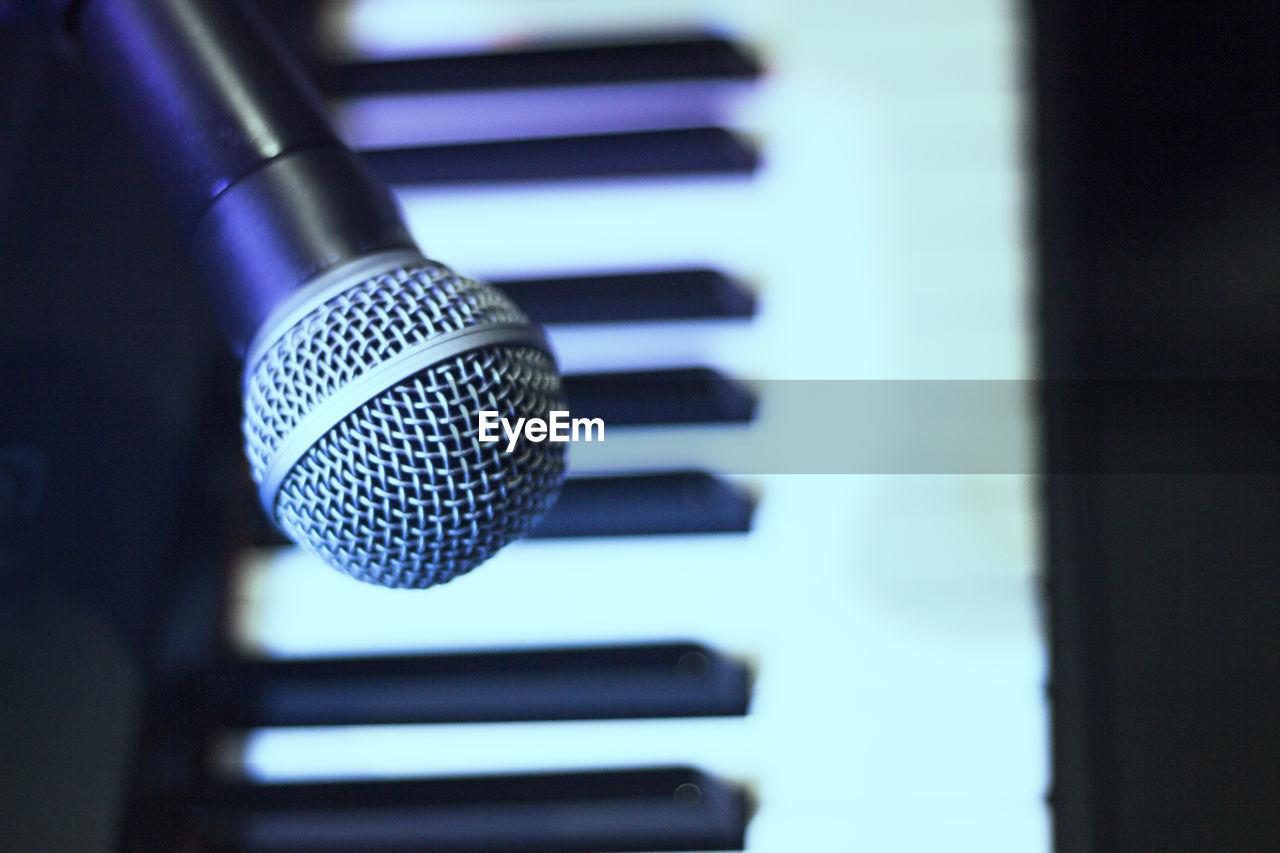 music, electronic device, microphone, input device, arts culture and entertainment, technology, indoors, close-up, piano, blue, musical instrument, performance, no people, communication, sound recording equipment, focus on foreground, musical equipment, selective focus, studio, recording studio