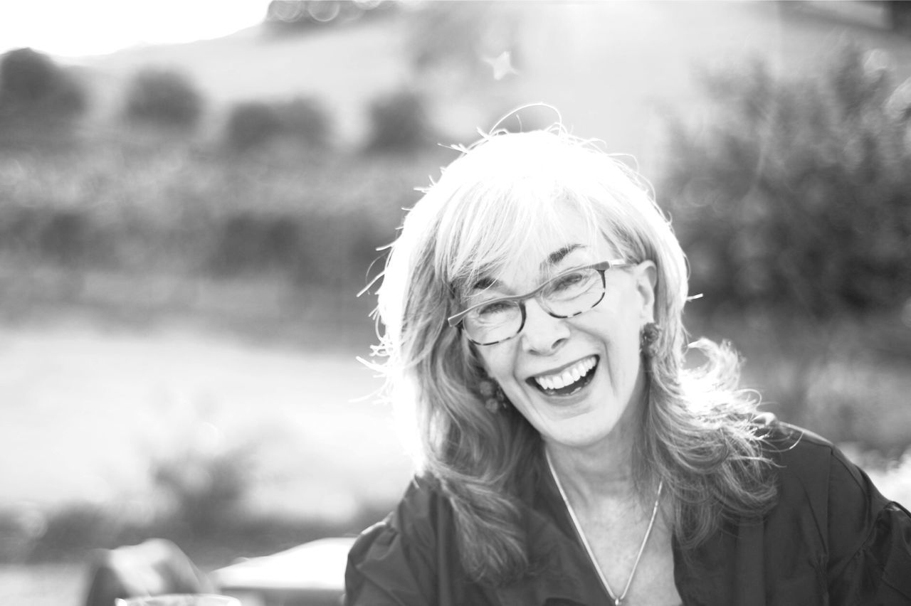 Portrait of happy mature woman on field