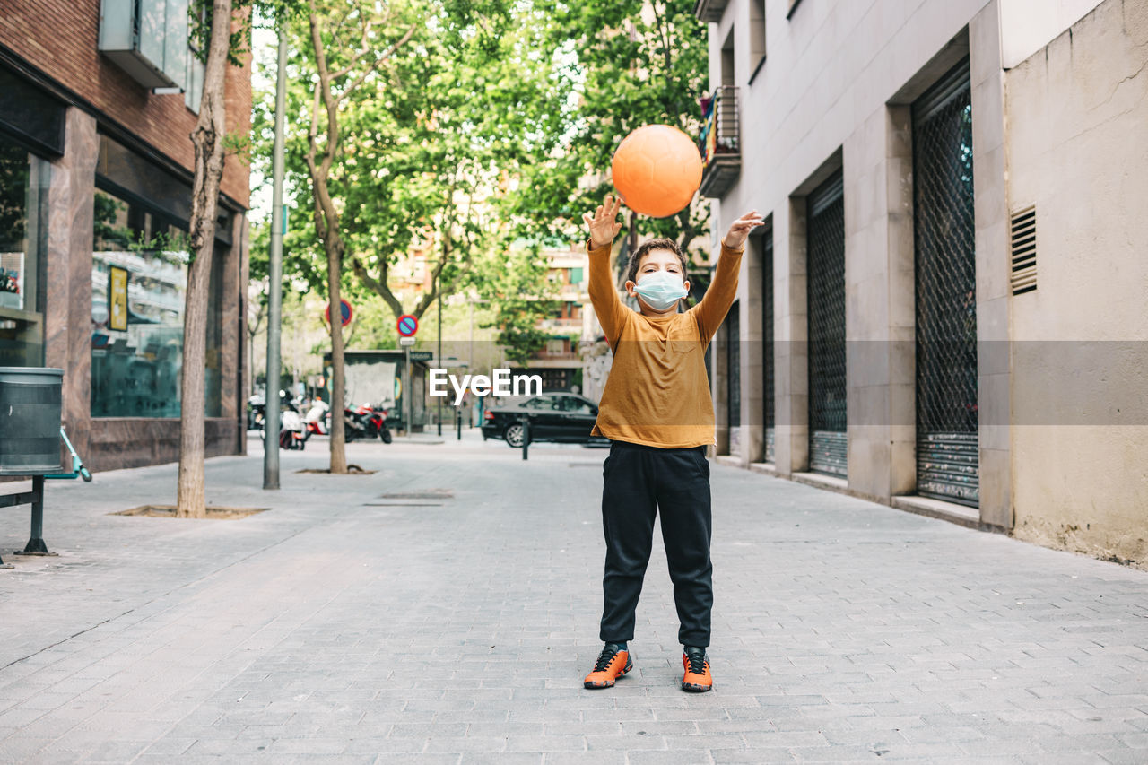 Full length of boy playing with ball