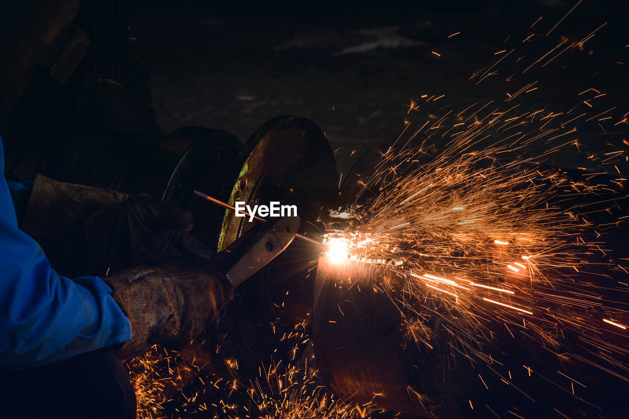 Cropped image of worker welding metal