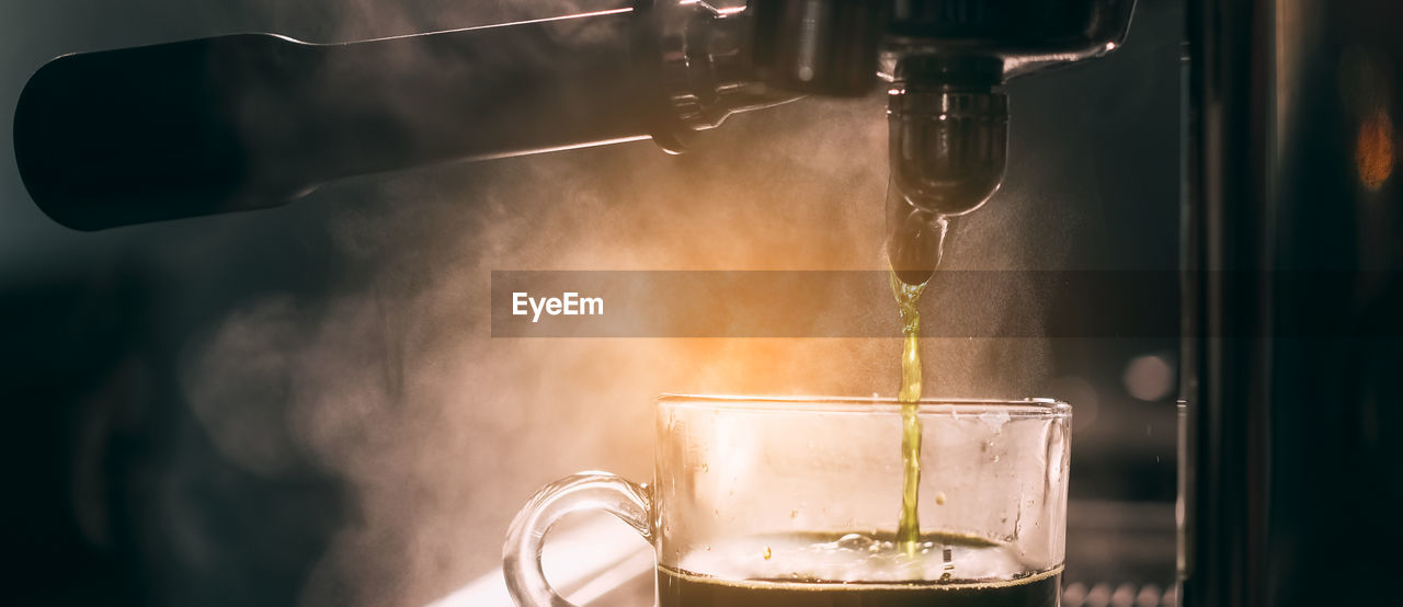 Barista add coffee bean roaster into coffee machine at coffee shop