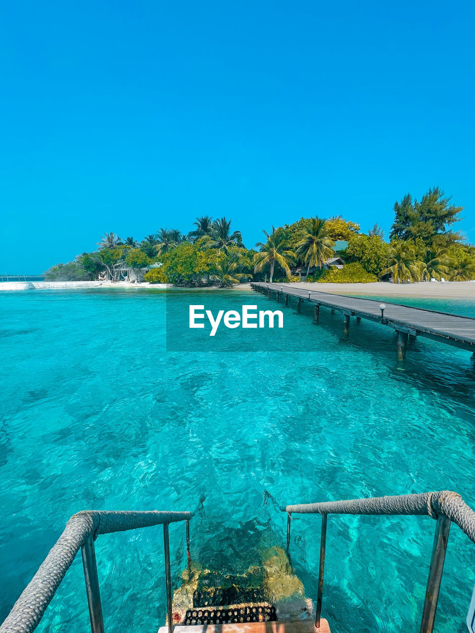 Scenic view of sea against clear blue sky