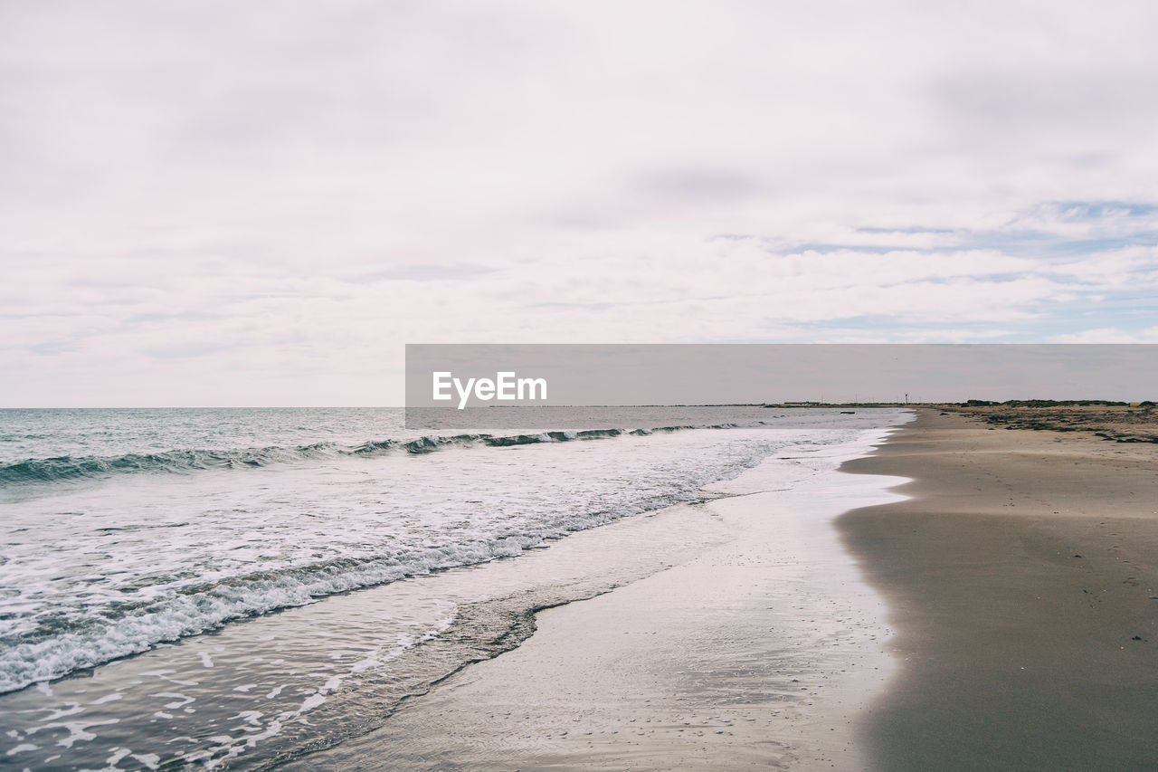 Lonely beach in the delta del ebro, tarragona, spain. the day is cloudy and windy.