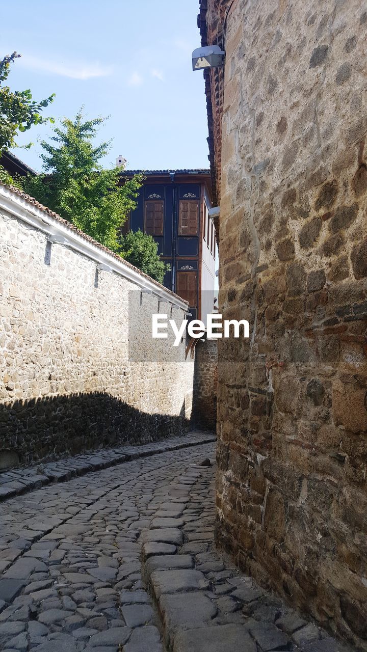 VIEW OF ALLEY AMIDST HOUSES