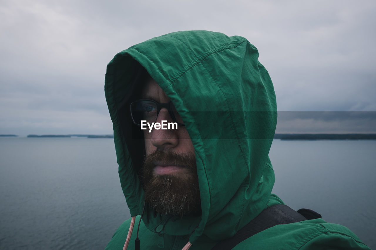 Portrait of man in sea against sky