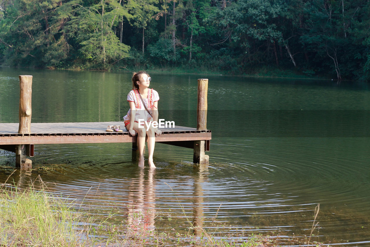 WOMAN LOOKING AT LAKE