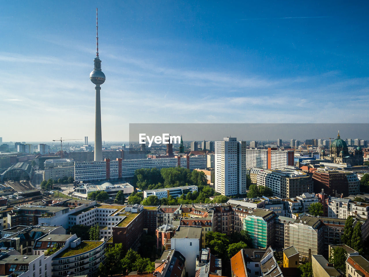 Fernsehturm with cityscape against sky