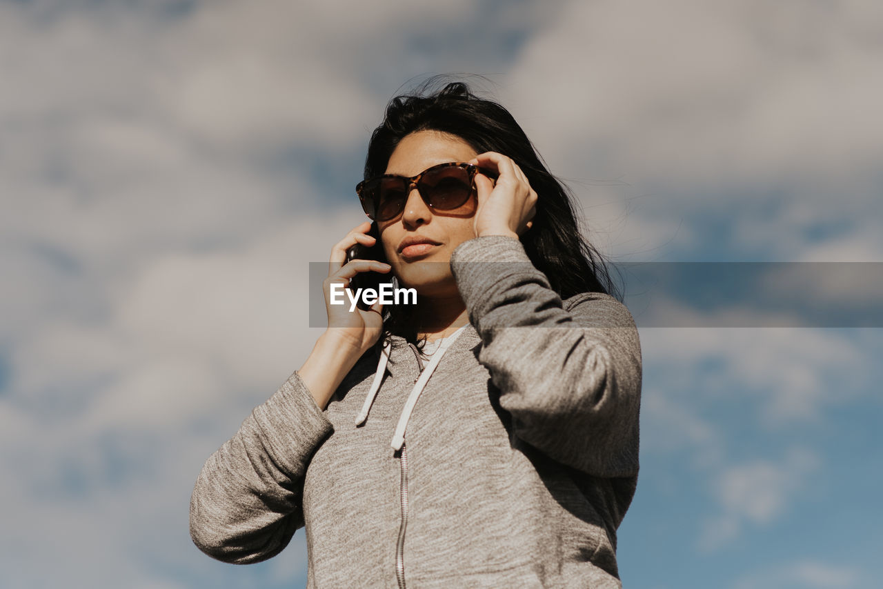 Portrait of beautiful hispanic woman talking on the phone