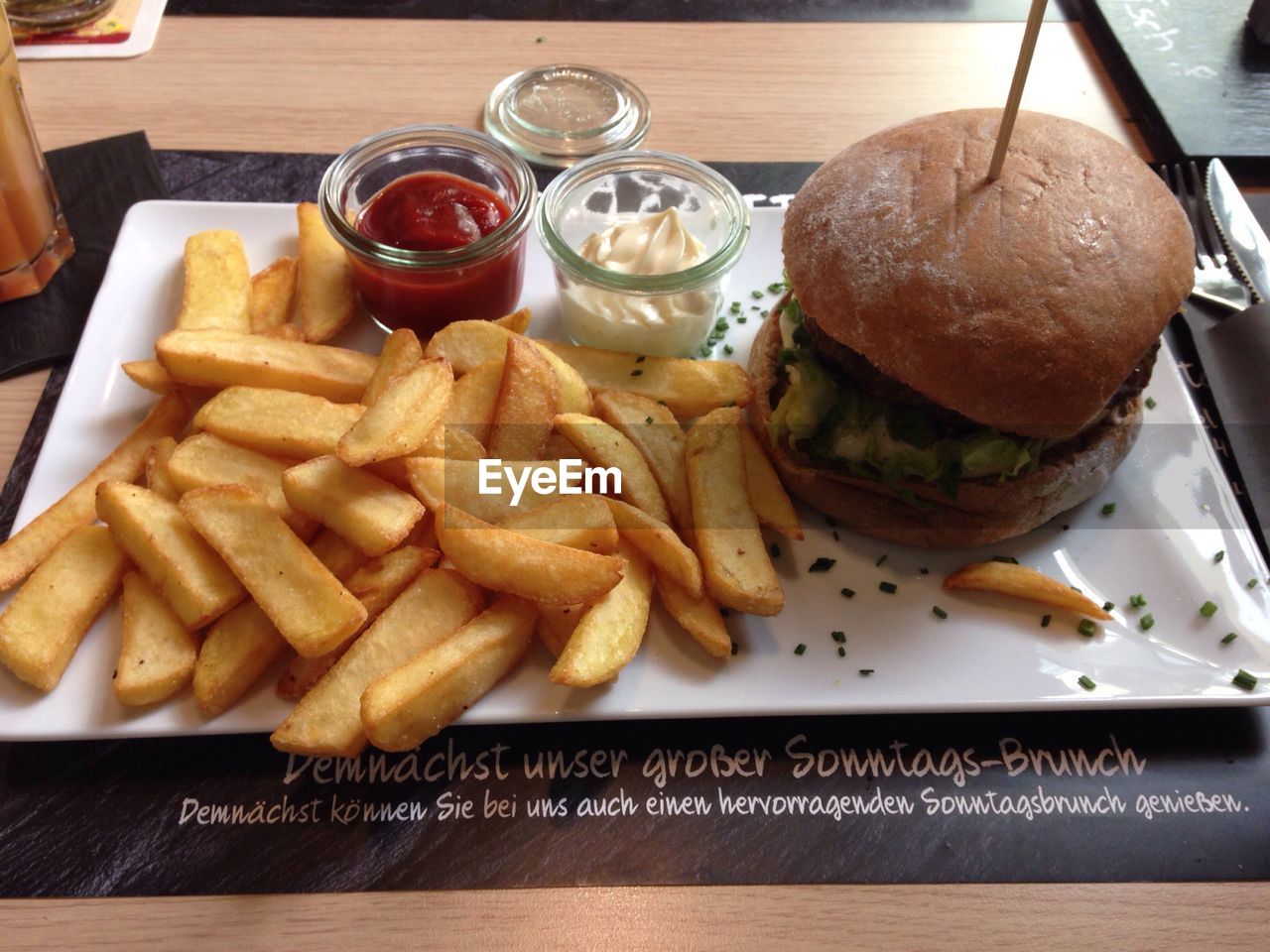 High angle view of burger and french fries served in tray on table