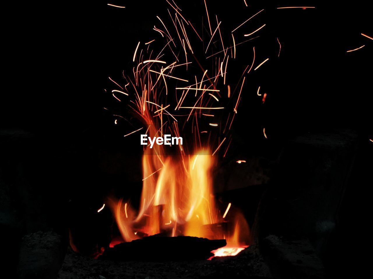 BONFIRE AGAINST FIRE AT NIGHT