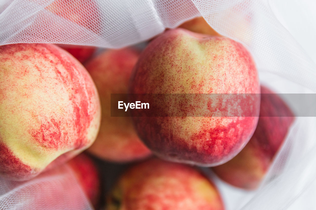 Close-up of apples in sustainable ecofriendly mesh bag on table