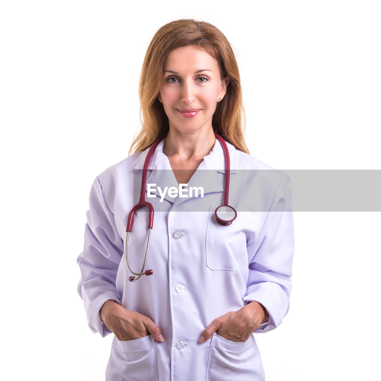 Portrait of doctor standing against white background